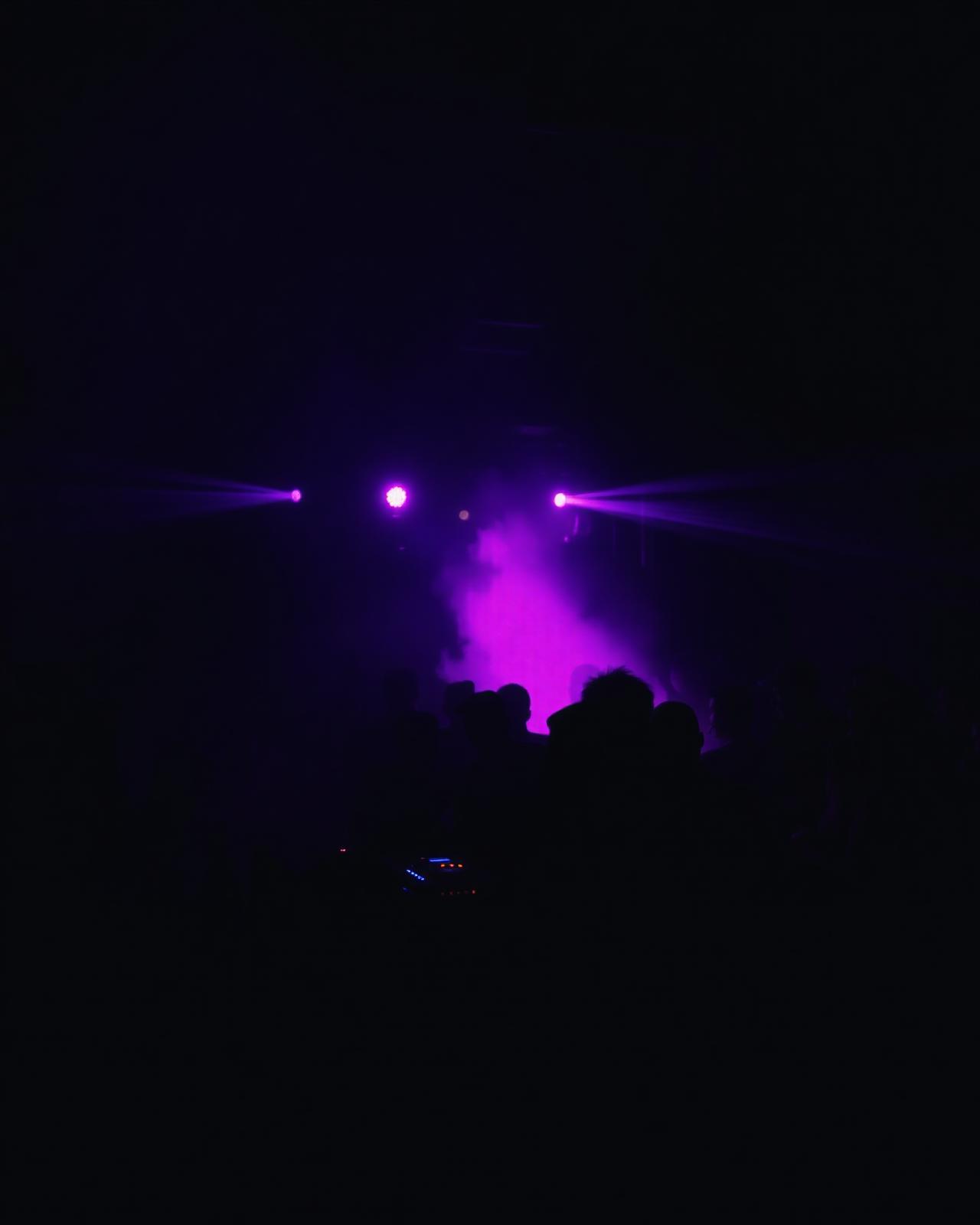DJ commanding a packed dance floor